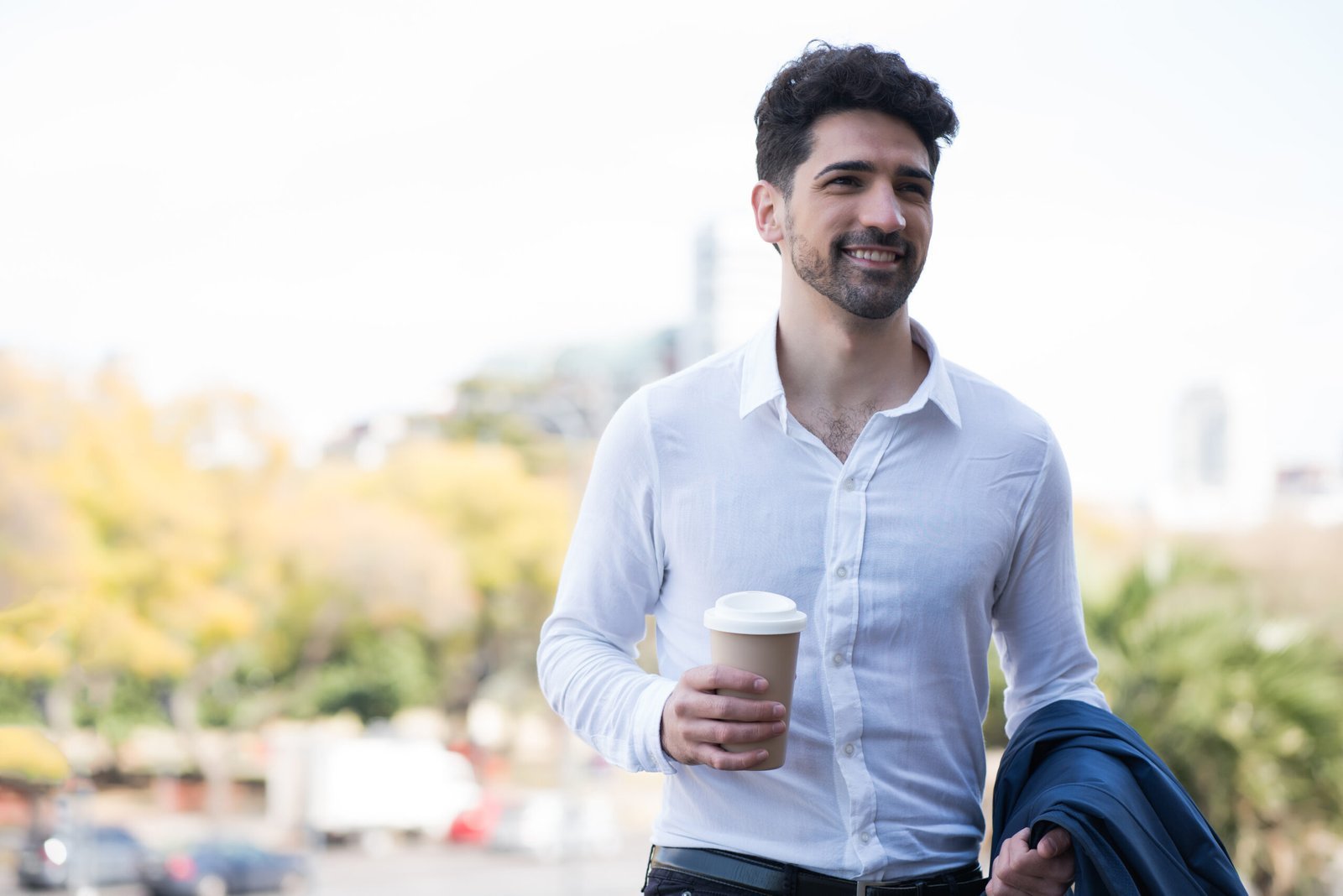 businessman-holding-a-cup-of-coffee-on-way-to-work-2024-10-18-05-24-01-utc-scaled.jpg
